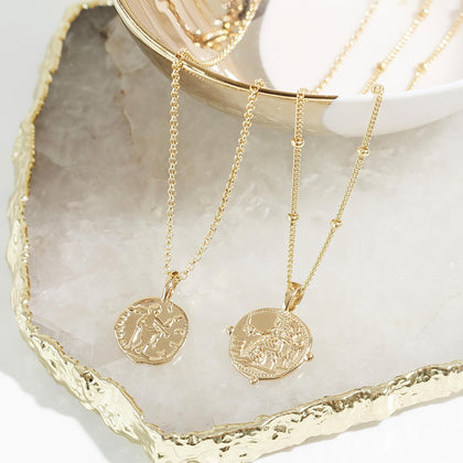 Gold Aphrodite and Athena necklaces.